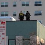 Spectators found the best vantage point on top of a roof near the corner of A Street and 4th Avenue overlooking the trail for the ceremonial start of the 45th Iditarod sled dog race Saturday, March 4, 2017 in Anchorage, Alaska. (Elizabeth Earl/Peninsula Clarion)