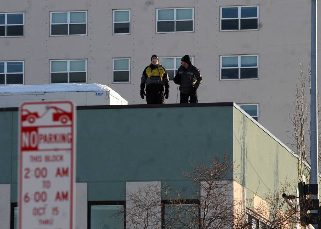 Spectators found the best vantage point on top of a roof near the corner of A Street and 4th Avenue overlooking the trail for the ceremonial start of the 45th Iditarod sled dog race Saturday, March 4, 2017 in Anchorage, Alaska. (Elizabeth Earl/Peninsula Clarion)