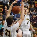 Ninilchik&rsquo;s Dalton Geppert (5) teams up with Austin White (33) to block the shot of Nikolaevsk&rsquo;s Anfim Kalugin in Friday&rsquo;s Peninsula Conference boys championship game at Homer High School. (Photo by Joey Klecka/Peninsula Clarion)