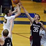 Nikolaevsk&rsquo;s Zachary Trail (35) puts a hand up on NInilchik&rsquo;s Austin White in Friday&rsquo;s Peninsula Conference boys championship game at Homer High School. (Photo by Joey Klecka/Peninsula Clarion)