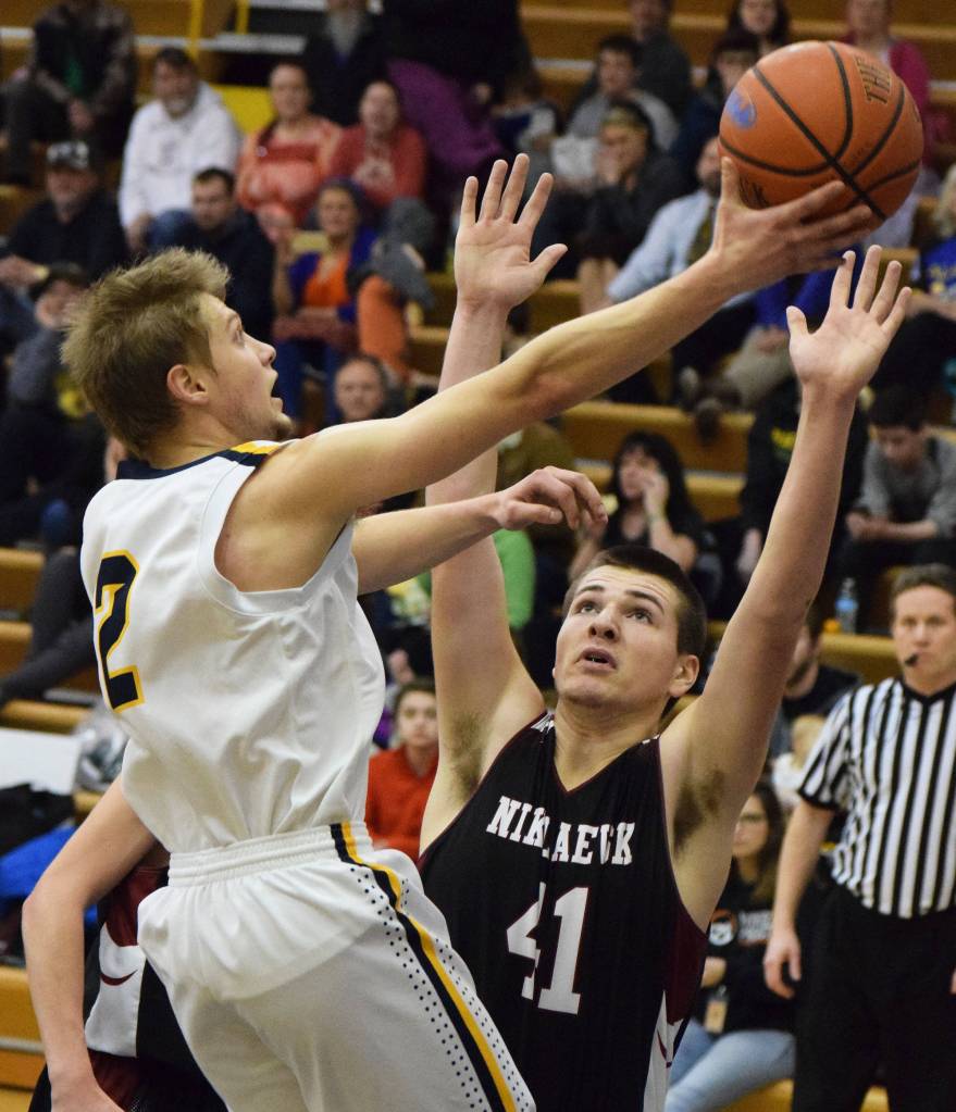 Nikolaevsk&rsquo;s Michael Trail (41) puts a wall up on Ninilchik&rsquo;s Tyler Presley in Friday&rsquo;s Peninsula Conference boys championship game at Homer High School. (Photo by Joey Klecka/Peninsula Clarion)