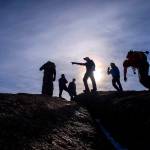 Tony Eichstadt, pointing, and the dozen mountaineers climbing with Eric Swab Tuesday, Jan. 31, 2017, scramble to the summit of Cap Rock near Palmer Lake, Colo., while on their weekly trek exploring the remote and historic spots in the backcountry of the Pikes Peak region. (Christian Murdock/The Gazette via AP)