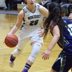 Nikiski&rsquo;s Bethany Carstens (20) drives into a pack of Redington defenders, Thursday, March 9, 2017, at the Southcentral Conference tournament at Nikiski High School. (Photo by Joey Klecka/Peninsula Clarion)