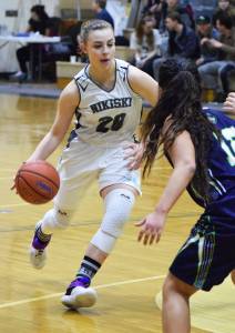 Nikiski&rsquo;s Bethany Carstens (20) drives into a pack of Redington defenders, Thursday, March 9, 2017, at the Southcentral Conference tournament at Nikiski High School. (Photo by Joey Klecka/Peninsula Clarion)
