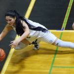 Nikiski&rsquo;s Brianna Vollertsen dives for a loose ball against Grace Christian, Friday at the Southcentral Conference basketball tournament at Nikiski High School. (Photo by Joey Klecka/Peninsula Clarion)