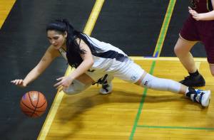 Nikiski&rsquo;s Brianna Vollertsen dives for a loose ball against Grace Christian, Friday at the Southcentral Conference basketball tournament at Nikiski High School. (Photo by Joey Klecka/Peninsula Clarion)