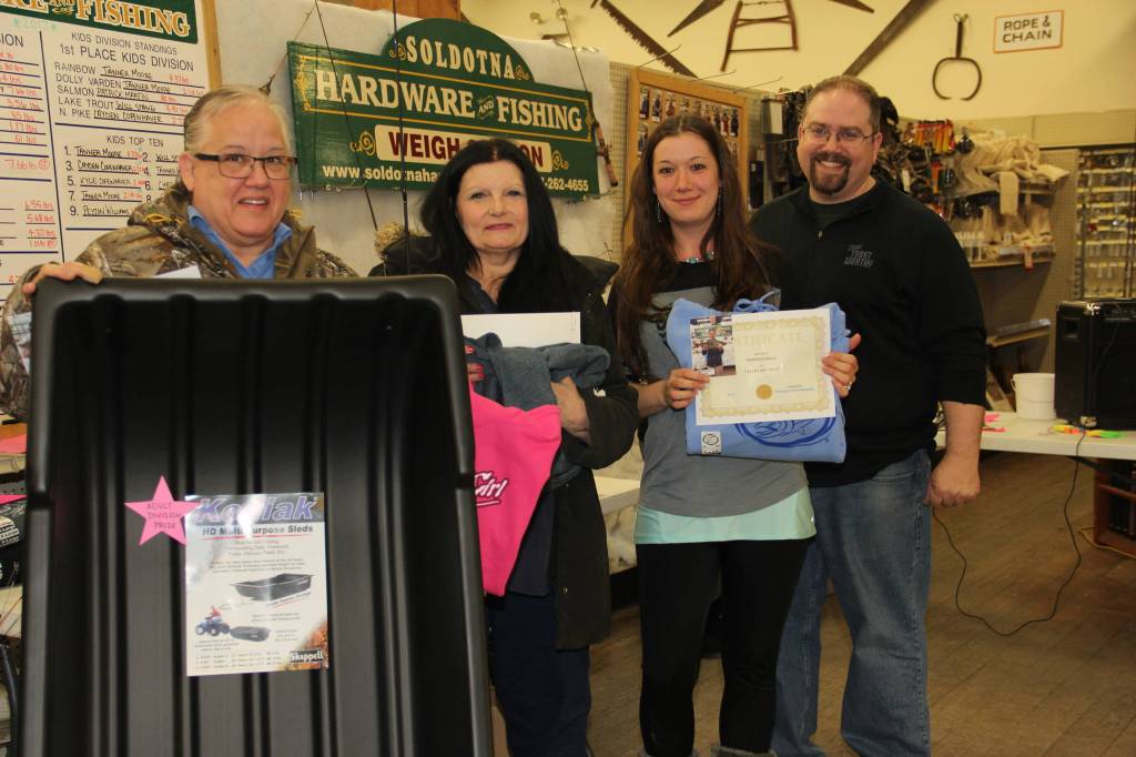Women claim their Ice Fishing Derby awards.