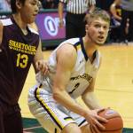 Ninilchik&rsquo;s Tyler Presley drives down the lane against Shaktoolik&rsquo;s Joshua Takak (13) Thursday, March 16, 2017, afternoon at the Class 1A state basketball tournament at the Alaska Airlines Center in Anchorage. (Photo by Joey Klecka/Peninsula Clarion)
