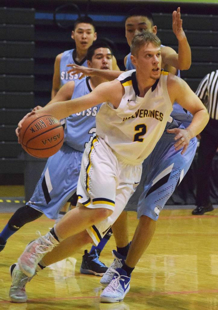 Ninilchik&rsquo;s Tyler Presley (2) darts to the rim against several Buckland defenders Friday, March 17, 2017 in a Class 1A state tournament semifinal held at the Alaska Airlines Center in Anchorage. (Photo by Joey Klecka/Peninsula Clarion)