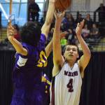 Nikolaevsk&rsquo;s Michael Trail shoots with Hydaburg defender Mike Eaglestaff blocking Friday, March 17, 2017, at the Class 1A state tournament held at the Alaska Airlines Center in Anchorage. (Photo by Joey Klecka/Peninsula Clarion)
