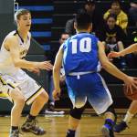 Ninilchik&rsquo;s Matt Bartolowits defends Gambell&rsquo;s Wallace Ungwiluk (10) in the Class 1A boys state championship Saturday, March 18, 2017, at the Alaska Airlines Center in Anchorage. (Photo by Joey Klecka/Peninsula Clarion)