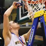 Ninilchik guard Dalton Geppert cuts down part of the basketball hoop netting following the Class 1A boys state championship Saturday at the Alaska Airlines Center in Anchorage. (Photo by Joey Klecka/Peninsula Clarion)