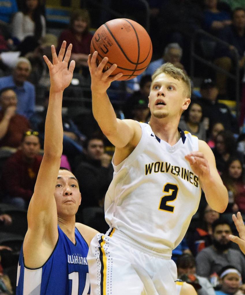 Ninilchik&rsquo;s Tyler Presley (2) scores on a layup over Gambell&rsquo;s Brian Campbell in the Class 1A boys state championship Saturday, March 18, 2017, at the Alaska Airlines Center in Anchorage. (Photo by Joey Klecka/Peninsula Clarion)
