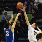 Ninilchik&rsquo;s Austin White (right) puts a block on Gambell&rsquo;s Andrew Aningayou in the Class 1A boys state championship Saturday, March 18, 2017, at the Alaska Airlines Center in Anchorage. (Photo by Joey Klecka/Peninsula Clarion)