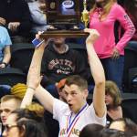 Ninilchik senior Austin White holds the championship trophy high above his head after the Class 1A state championship game Saturday, March 18, 2017, at the Alaska Airlines Center in Anchorage. (Photo by Joey Klecka/Peninsula Clarion)