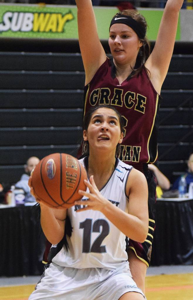 Nikiski&rsquo;s Brianna Vollertsen (12) looks for a shot against Grace Christian&rsquo;s Makenna Shamburger in the Class 3A state quarterfinal contest Thursday, March 23, 2017, at the Alaska Airlines Center in Anchorage. (Photo by Joey Klecka/Peninsula Clarion)