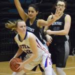Sitka&rsquo;s Zosha Krupa (12) looks for a way out against Nikiski&rsquo;s Brianna Vollertsen (center) and Ayla Pitt, in Friday&rsquo;s Class 3A state semifinal at the Alaska Airlines Center in Anchorage. (Photo by Joey Klecka/Peninsula Clarion)