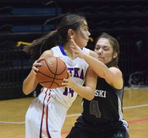 Nikiski&rsquo;s Emma Wik (right) tries to force a turnover on Sitka&rsquo;s Marlis Boord in Friday&rsquo;s Class 3A state semifinal at the Alaska Airlines Center in Anchorage. (Photo by Joey Klecka/Peninsula Clarion)