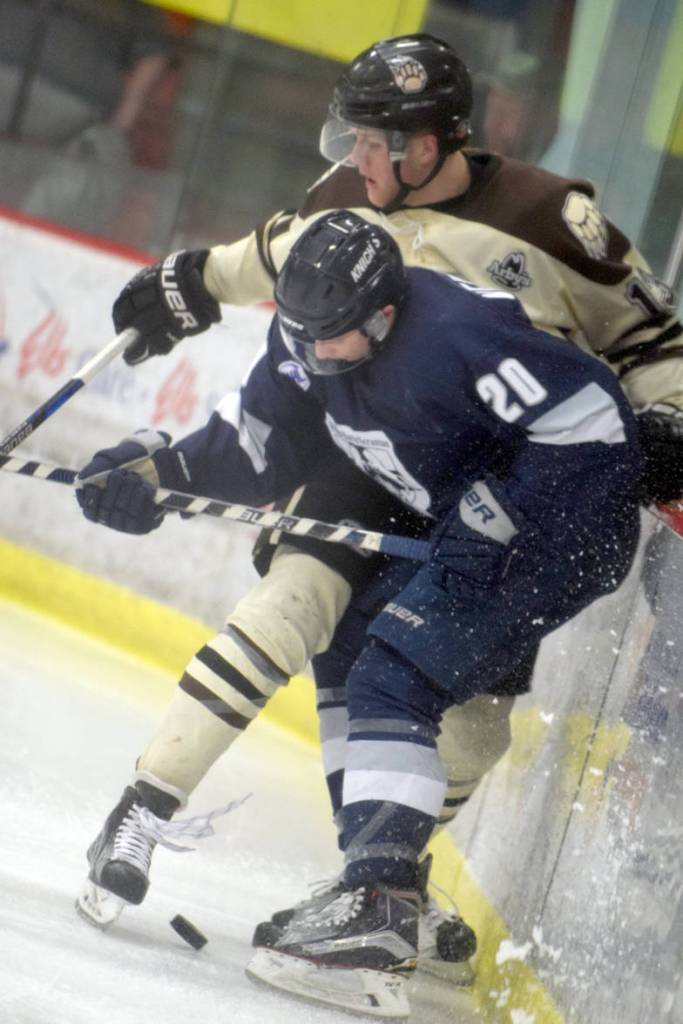Kenai River Brown Bears forward Tyler Rock and Wilkes-Barre/Scranton (Pennsylvania) Knights defenseman Joey Verkerke battle for the puck along the boards Friday, March 24, 2017, at the Soldotna Regional Sports Complex. (Photo by Jeff Helminiak/Peninsula Clarion)