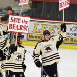 Kenai River&rsquo;s Jonathan Marzec (left) and Jake Friedman hold up signs Saturday night advocating for the return of the Brown Bears organization next season at the Soldotna Regional Sports Complex.