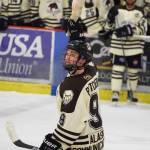 Kenai River&rsquo;s Evan Butcher hoists up a salmon in a victory salute after the Brown Bears scored the opening goal Saturday night against the Wilkes-Barre/Scranton Knights at the Soldotna Regional Sports Complex.