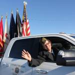 VFW Post 10046 commander Anne Toutant waves as Vets parade the Colors.