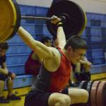 Kenai Central sophomore Jacob Anderson cleans and jerks Wednesday evening at the 11th biannual CrossFit Competition at Soldotna High School. (Photo by Joey Klecka/Peninsula Clarion)