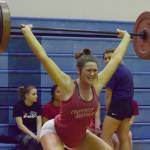 Kenai Central senior Lara Creighton cleans and jerks Wednesday evening at the 11th biannual CrossFit Competition at Soldotna High School. (Photo by Joey Klecka/Peninsula Clarion)