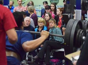 A crowd of onlookers watch as Soldotna freshman Ateliano Faletoi-Eli attempts a squat lift Wednesday evening at the 11th biannual CrossFit Competition at Soldotna High School. (Photo by Joey Klecka/Peninsula Clarion)