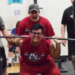 Kenai Central senior Jonathan Delgado attempts to break the 11th-12th grade boys squat record Wednesday evening at the 11th biannual CrossFit Competition at Soldotna High School. (Photo by Joey Klecka/Peninsula Clarion)