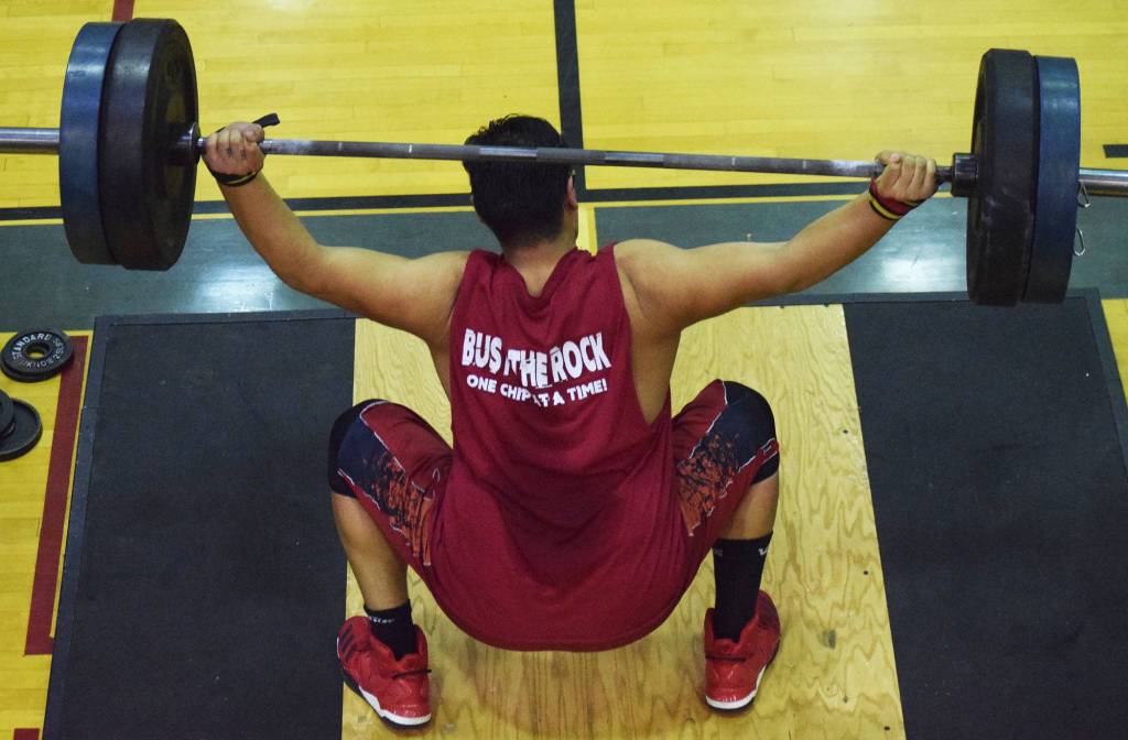 Kenai Central senior Jonathan Delgado attempts a lift Wednesday evening at the 11th biannual CrossFit Competition at Soldotna High School. (Photo by Joey Klecka/Peninsula Clarion)