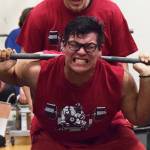 Kenai Central senior Jonathan Delgado attempts to break the 11th-12th grade boys squat record Wednesday evening at the 11th biannual CrossFit Competition at Soldotna High School. (Photo by Joey Klecka/Peninsula Clarion)