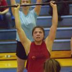 Kenai Central senior Julieanne Wilson (middle) lifts during the Fight Gone Bad event Wednesday evening at the 11th biannual CrossFit Competition at Soldotna High School. (Photo by Joey Klecka/Peninsula Clarion)