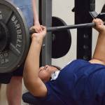 Soldotna freshman Ituau Tuisaula benches in the 9th-10th grade girls contest Wednesday evening at the 11th biannual CrossFit Competition at Soldotna High School. (Photo by Joey Klecka/Peninsula Clarion)