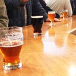 Patrons stand at the bar with their drink Friday, March 31, 2017 at Kenai River Brewing Company in Soldotna, Alaska. Soldotna is one of several communities in the state with establishments that opened under public convenience licenses, which would be transitioned to restaurant or eating place license types under SB 76, a rewrite of Alaska&rsquo;s alcohol statutes. (Megan Pacer/Peninsula Clarion)