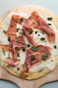 This February 2017 photo shows a burrata and prosciutto pizza in New York. This dish is from a recipe by Katie Workman. (Sarah Crowder via AP)