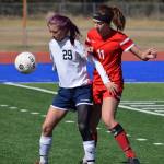 Soldotna&rsquo;s Abi Tuttle (29) shields Wasilla&rsquo;s Hayley Brandon from the ball May 7, 2016, at Justin Maile Field in Soldotna. (Photo by Joey Klecka/Peninsula Clarion)