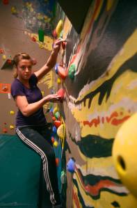 Kara Johnston makes her way through a bouldering route on River City Wellness Center&rsquo;s new climbing wall on Saturday, April 8, 2017 in Soldotna, Alaska.