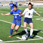 Soldotna freshman Faith Glassmaker (9) fights for possession against Palmer&rsquo;s Emma Obeso Friday afternoon at Justin Maile Field in Soldotna. (Photo by Joey Klecka/Peninsula Clarion)
