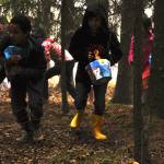 Kids race into the woods in search of Easter eggs during an Easter party hosted by the Kenai Elks Lodge