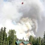 A helicopter returns from a dumping run on the north shore of the Kenai River during the Card Street wildfire in this June 16, 2015 photo. (Ben Boettger/Peninsula Clarion, file)