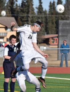 Kenai Central&rsquo;s Luke Beiser (24) heads a ball towards the Soldotna net early in Tuesday&rsquo;s conference game at Ed Hollier Field in Kenai. (Photo by Joey Klecka/Peninsula Clarion)