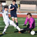 Kenai Central&rsquo;s Zack Tuttle slots a goal past Soldotna goalkeeper Chase Miller in Tuesday&rsquo;s conference game at Ed Hollier Field in Kenai. (Photo by Joey Klecka/Peninsula Clarion)