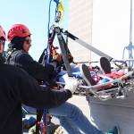 Mountain Village School student Simon Andrews, 18, rappels down the side of a wall carrying his &ldquo;patient,&rdquo; 17-year-old Leona Wasky of Alakanuk High School, under the instruction of Nikiski Fire Department Training and Safety Officer Bryan Crisp on Wednesday, April 19, 2017 in Nikiski, Alaska. A handful of Western Alaska students received basic firefighting training at the Nikiski Fire Department all week through Excel Alaska&rsquo;s Camp Kick Ash. (Megan Pacer/Peninsula Clarion)