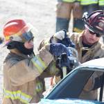 Steven Jacob, 19, from the Kuskokwim Learning Academy, practices using the jaws of life on a car with the help of instructor Bryan Crisp of the Nikiski Fire Department (right) on Thursday, April 20, 2017 at the department&rsquo;s Station No. 2 in Nikiski, Alaska. Jacob and several other Western Alaska students spent the week getting basic firefighter training through Excel Alaska&rsquo;s Camp Kick Ash. (Megan Pacer/Peninsula Clarion)