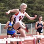 Kenai Central&rsquo;s Katie Kilfoyle hurdles a barrier in Saturday&rsquo;s 300-meter girls race at the Kenai Invitational at Ed Hollier Field in Kenai. (Photo by Joey Klecka/Peninsula Clarion)