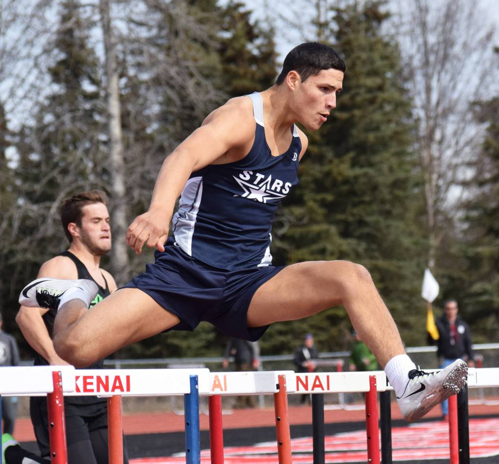 Soldotna&rsquo;s Abraham Van Hout leaps a barrier in Saturday&rsquo;s boys 300-meter hurdles race at the Kenai Invitational at Ed Hollier Field in Kenai. (Photo by Joey Klecka/Peninsula Clarion)