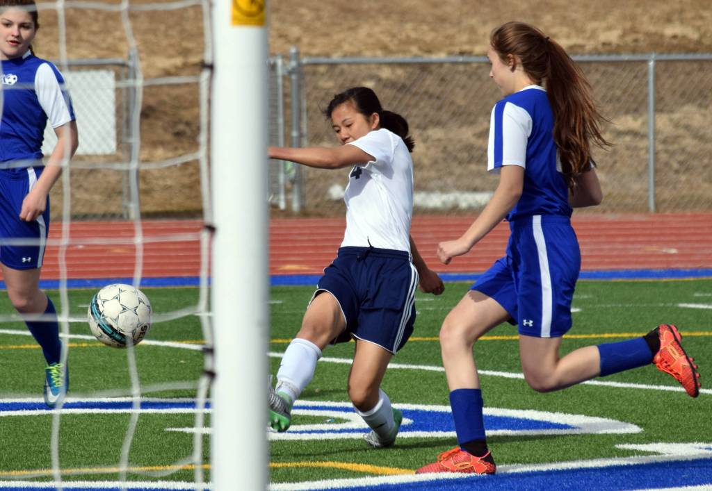 Soldotna&rsquo;s Meijan Leaf (center) sends a shot to Kodiak&rsquo;s goal Friday at Justin Maile Field in Soldotna (Photo by Joey Klecka/Peninsula Clarion)