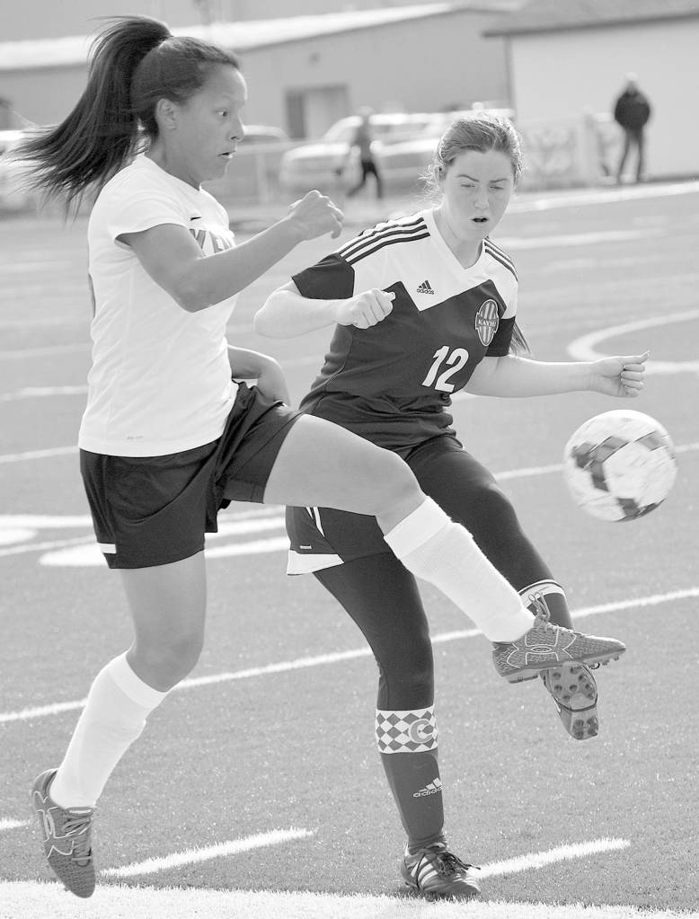 Kenai Central&rsquo;s Lexy Carrasco at Ketchikan&rsquo;s Cameron Edwards battle for the ball Wednesday at Kenai Central High School. (Photo by Jeff Helminiak/Peninsula Clarion)