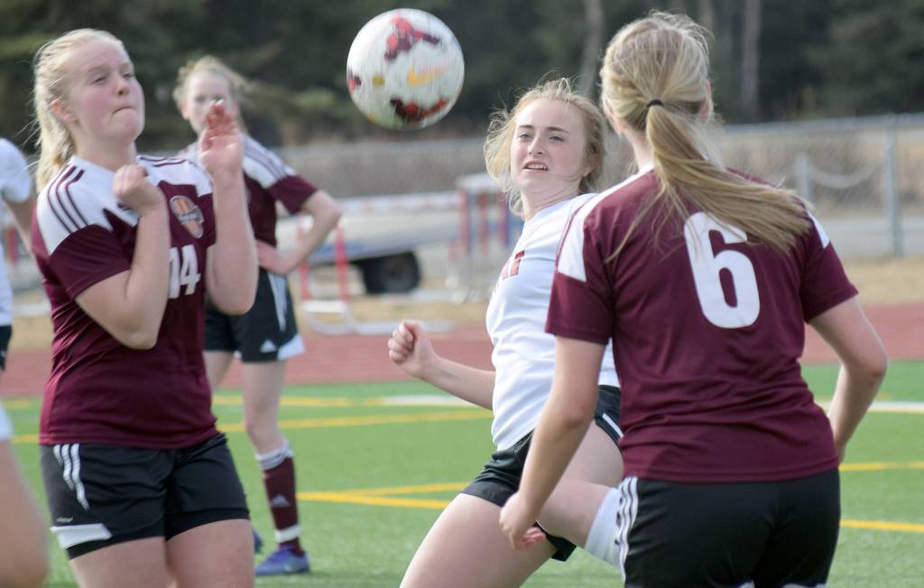 Kenai Central&rsquo;s Liz Hanson tries to get a shot off between Ketchikan&rsquo;s Angel Spurgeon and Aleks Bolshakoff on Wednesday, April 26, 2017, at Kenai Central High School. (Photo by Jeff Helminiak/Peninula Clarion)